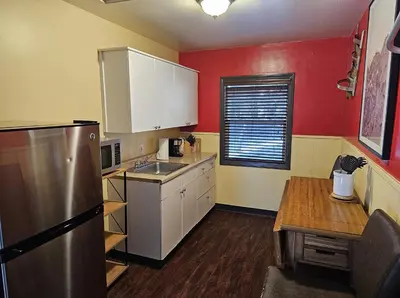 a kitchen with a stainless steel refrigerator and red walls at Holiday Haus in Mammoth Lakes