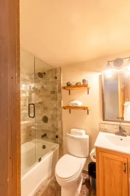 a bathroom with a toilet and a shower and a sink at Cozy Aspen Grove 2 bed 2 bath condo in Truckee