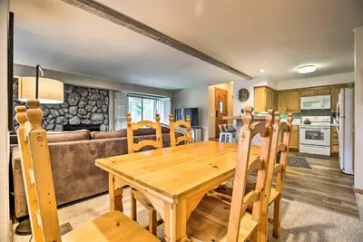 a kitchen and dining room with a wooden table and chairs at Hot Tub Access Mammoth Lakes Nature Escape! in Mammoth Lakes