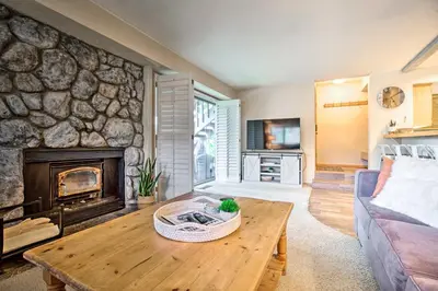 a living room with a couch and a fireplace at Hot Tub Access Mammoth Lakes Nature Escape! in Mammoth Lakes
