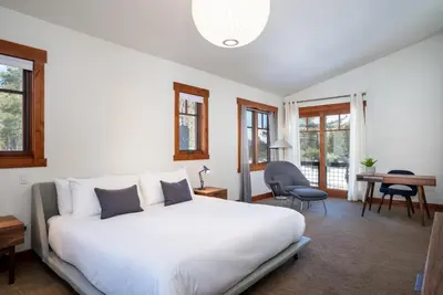 a bedroom with a large white bed and a desk at Annie's Loop, Gray's Crossing 10215 in Truckee