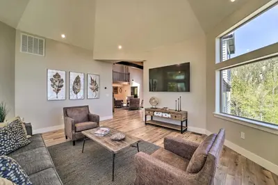 a living room with a couch and a table at Hot Tub, Pool Table Luxe Reno Chalet with Mtn View! in Reno