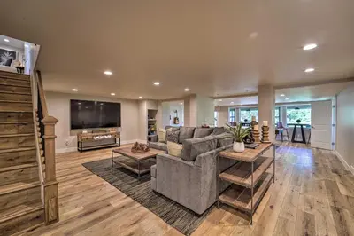 a living room with a couch and a tv at Hot Tub, Pool Table Luxe Reno Chalet with Mtn View! in Reno