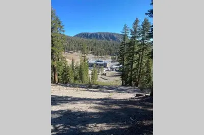a view of a parking lot from the forest at Comfy, Quiet, Condo near Lake Mary and the Village in Mammoth Lakes