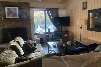 a living room with a couch and a fireplace at Comfy, Quiet, Condo near Lake Mary and the Village in Mammoth Lakes