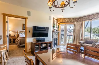 a living room with a television and a living room at Juniper Springs Lodge #413 - Luxury Ski in Ski out! 2 Bedroom in Mammoth Lakes
