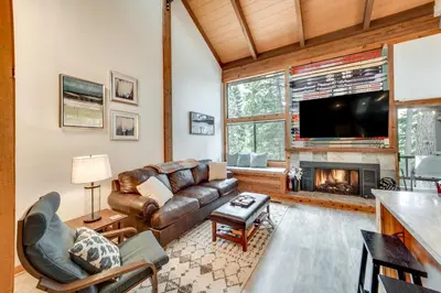 a living room with a couch and a fireplace at 1 Mi to Northstar Skiing Cozy Pet-Friendly Condo! in Truckee
