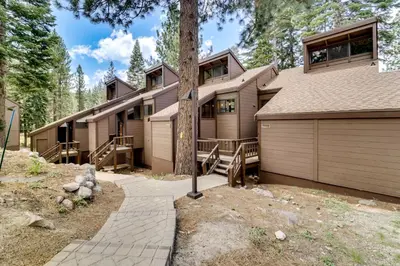a house with a garage and a tree at 1 Mi to Northstar Skiing Cozy Pet-Friendly Condo! in Truckee