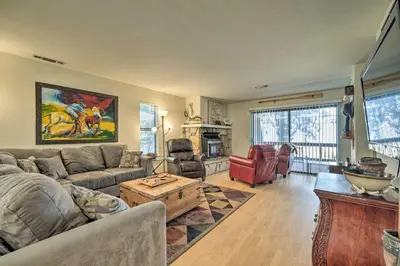 a living room with a couch and a table at Pine Mountain Lake Haven with Spacious Deck! in Groveland