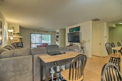 a living room with a couch and a laptop on a table at Pine Mountain Lake Haven with Spacious Deck! in Groveland