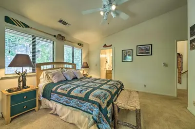 a bedroom with a bed and a ceiling fan at Pine Mountain Lake Haven with Spacious Deck! in Groveland