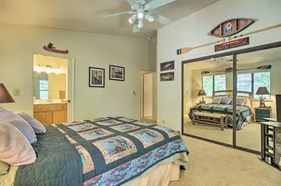 a bedroom with a bed and a mirror at Pine Mountain Lake Haven with Spacious Deck! in Groveland