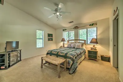 a bedroom with a bed and a ceiling fan at Pine Mountain Lake Haven with Spacious Deck! in Groveland