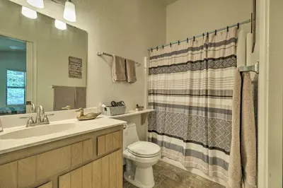 a bathroom with a sink and a toilet and a shower at Pine Mountain Lake Haven with Spacious Deck! in Groveland