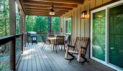 a screened in porch with a table and chairs at 12R Hilltop Haven in North Wawona