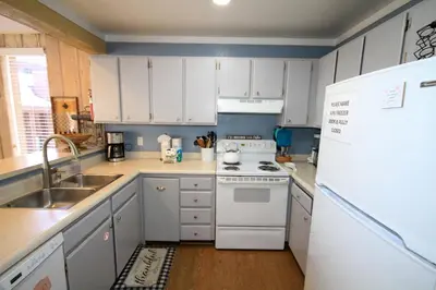 a kitchen with white appliances and a white refrigerator at Mammoth Ski Racquet Club 105 - Pet Friendly in Mammoth Lakes