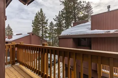 a balcony of a house with a snow covered roof at Mammoth Ski Racquet Club 105 - Pet Friendly in Mammoth Lakes