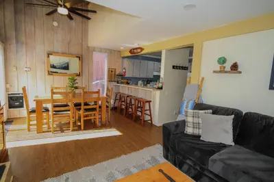 a living room and kitchen with a table and chairs at Mammoth Ski Racquet Club 105 - Pet Friendly in Mammoth Lakes