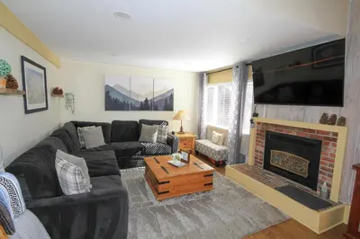 a living room with a couch and a fireplace at Mammoth Ski Racquet Club 105 - Pet Friendly in Mammoth Lakes