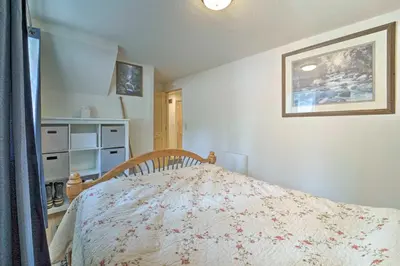 a bedroom with a bed and a picture on the wall at Half-Mi to Trails Rustic Soda Springs Cabin! in Soda Springs