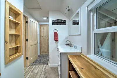 a small kitchen with a sink and a window at Half-Mi to Trails Rustic Soda Springs Cabin! in Soda Springs