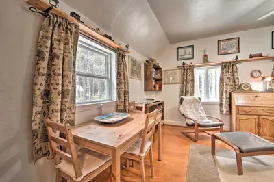 a dining room with a table and chairs and a window at Half-Mi to Trails Rustic Soda Springs Cabin! in Soda Springs