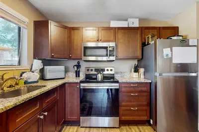 a kitchen with wooden cabinets and a stainless steel refrigerator at 11529 Snowpeak Way #619 in Truckee