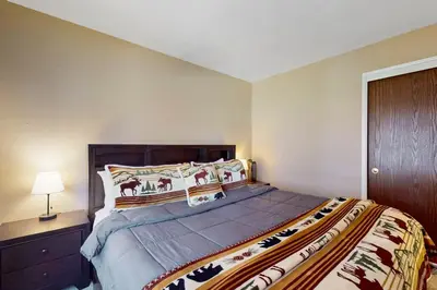 a bedroom with a large bed and a nightstand at 11529 Snowpeak Way #619 in Truckee