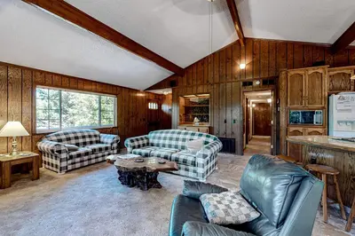 a living room with couches and a table at It's Cabin Time in Groveland