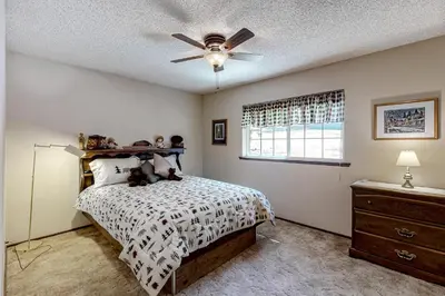a bedroom with a bed with a ceiling fan at It's Cabin Time in Groveland