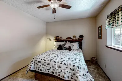 a bedroom with a bed with two teddy bears on it at It's Cabin Time in Groveland