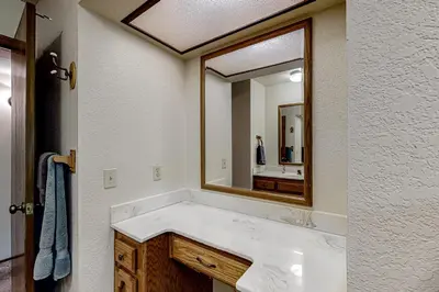 a bathroom with a sink and a large mirror at It's Cabin Time in Groveland