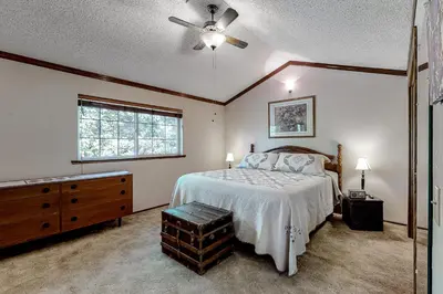 a bedroom with a bed and a dresser and a window at It's Cabin Time in Groveland