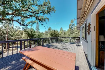 a wooden bench on the porch of a house at It's Cabin Time in Groveland