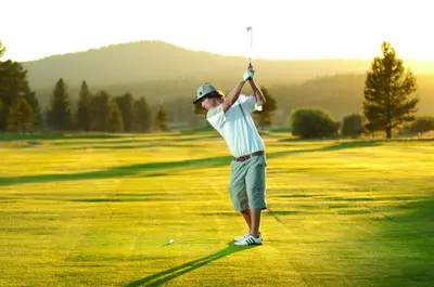 a man is playing golf on a golf course at Modern Hotel-Style Studio - Timber Creek Lodge #210 Hotel Room in Truckee