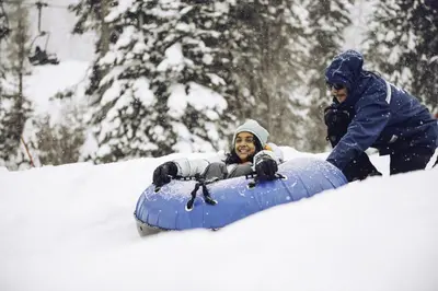 a man is riding on a snowboard in the snow at Modern Hotel-Style Studio - Timber Creek Lodge #210 Hotel Room in Truckee