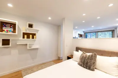 a bedroom with a bed with white walls and a window at Modern Hotel-Style Studio - Timber Creek Lodge #210 Hotel Room in Truckee