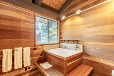 a wooden bathroom with a tub and a window at Beautiful 4-Bedroom Contemporary Mountain Home condo in Truckee
