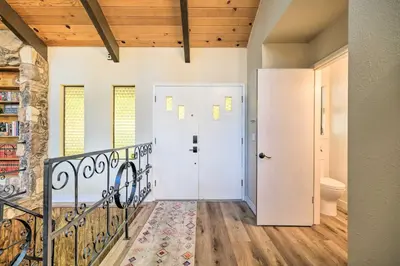 a hallway with a white door and a staircase at Pine Mountain Cabin with Hot Tub, 2 Mins to Marina! in Groveland