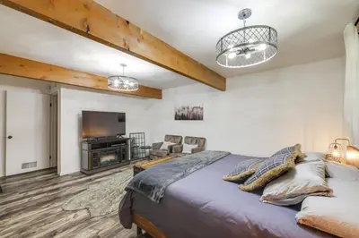 a bedroom with a bed and a flat screen tv at Cold Springs Escape AandC, Hot Tub, Generator, WiFi in Cold Springs