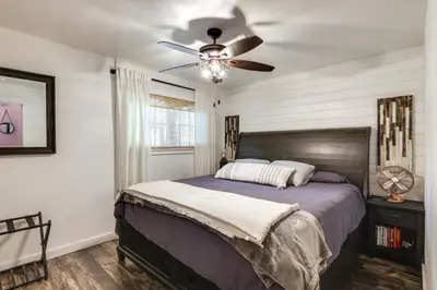 a bedroom with a bed with a ceiling fan at Cold Springs Escape AandC, Hot Tub, Generator, WiFi in Cold Springs