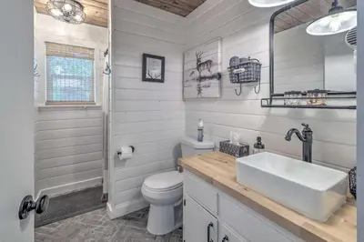 a white bathroom with a sink and a toilet at Cold Springs Escape AandC, Hot Tub, Generator, WiFi in Cold Springs
