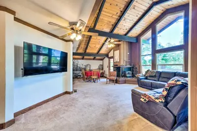 a living room with a couch and a tv at Cabin Less Than Half-Mi from Pine Mountain Lake Marina! in Groveland