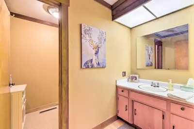 a bathroom with a sink and a mirror at Cabin Less Than Half-Mi from Pine Mountain Lake Marina! in Groveland