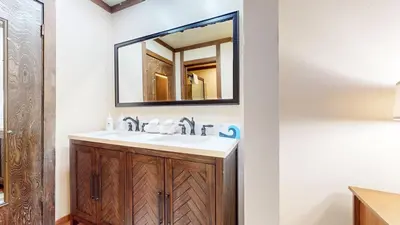 a bathroom with a sink and a mirror at Mammoth Estates #113 condo in Mammoth Lakes