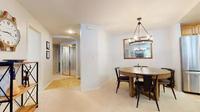 a kitchen and dining room with a table and a clock at Silver Bear #21 condo in Mammoth Lakes