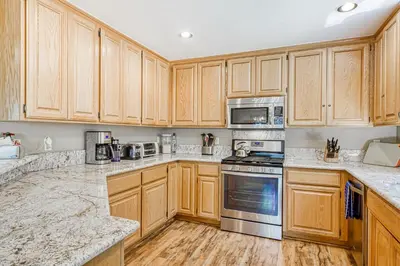 a kitchen with wooden cabinets and stainless steel appliances at Blue Antler in Truckee