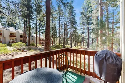 a balcony with a table and a chair on a porch at Tahome & Tahoe Place in Incline Village