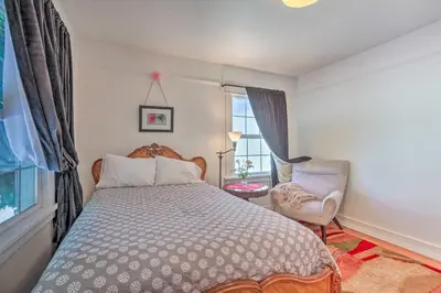 a bedroom with a bed and a chair and a window at Historic Reno Home on Riverwalk 1 Mi to Midtown in Reno