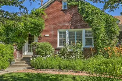 a brick house with a garden in front of it at Historic Reno Home on Riverwalk 1 Mi to Midtown in Reno